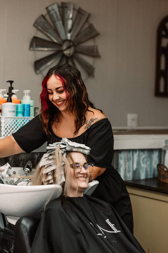 stylist emily alexander applying hair color for a client