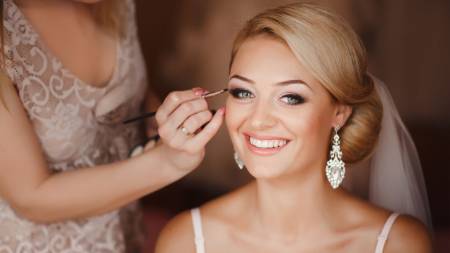 charismatic stylist entrance, radiant, taking a bow, photorealistic, a theatrical stage with a curtain backdrop, highly detailed, a quiet anticipation in the air, rich deep colors, focused spotlight beam, shot with a 90mm lens.