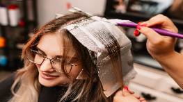 creative stylist intro, bold, designing an outfit, photorealistic, a lively workshop filled with materials and ideas, highly detailed, the rustle of fabrics and snipping scissors, vivid color combinations, bright fluorescent lights, shot with a 35mm lens.